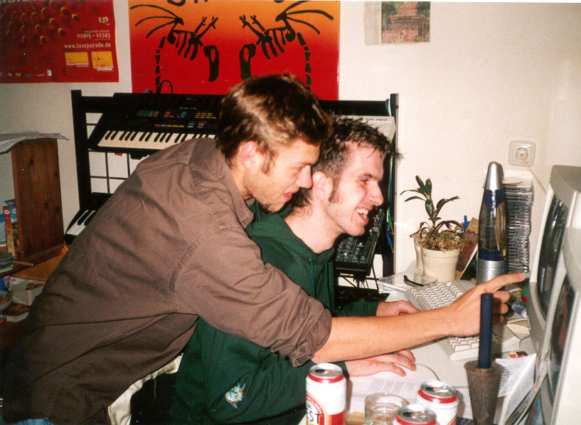 Two musicians working together at a computer in the home studio